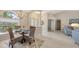 A lovely dining room with a glass table and arched windows provides a light and airy atmosphere at 5698 Country Walk Ln, Sarasota, FL 34233