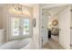 Welcoming foyer featuring tile flooring, glass double doors, and views into living spaces at 5698 Country Walk Ln, Sarasota, FL 34233