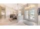 Inviting foyer with decorative glass doors, chandelier, and light-filled dining area at 5698 Country Walk Ln, Sarasota, FL 34233