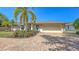 Charming home with a brick driveway, two-car garage, and lush landscaping at 5698 Country Walk Ln, Sarasota, FL 34233