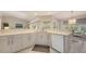A spacious kitchen with a breakfast bar features modern countertops, sleek cabinetry, and an abundance of natural light at 5698 Country Walk Ln, Sarasota, FL 34233