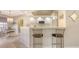 Kitchen features a breakfast bar with seating and white cabinetry at 5698 Country Walk Ln, Sarasota, FL 34233