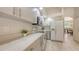 Bright kitchen with modern appliances, countertops, and white cabinetry at 5698 Country Walk Ln, Sarasota, FL 34233