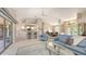 Open concept living room with view of kitchen and dining area, and sliding glass doors at 5698 Country Walk Ln, Sarasota, FL 34233