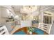 Open concept living space connects kitchen, living, and dining areas in bright, inviting layout at 5698 Country Walk Ln, Sarasota, FL 34233