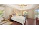 Spacious main bedroom features hardwood floors, soft lighting, and multiple windows, creating a peaceful retreat at 5698 Country Walk Ln, Sarasota, FL 34233