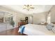 Bright main bedroom with tray ceiling, sliding glass doors, and rich hardwood flooring is a retreat at 5698 Country Walk Ln, Sarasota, FL 34233