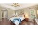 Comfortable main bedroom offers hardwood floors, neutral paint, and ample natural light for a serene setting at 5698 Country Walk Ln, Sarasota, FL 34233