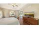 A serene main bedroom is filled with light and features hardwood floors and a sliding glass door to the outside at 5698 Country Walk Ln, Sarasota, FL 34233