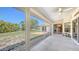 Covered patio with views of a landscaped yard and water feature, perfect for outdoor relaxation at 5698 Country Walk Ln, Sarasota, FL 34233