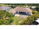 Expansive home featuring a screened lanai and outdoor patio, nestled within a landscaped backyard at 5698 Country Walk Ln, Sarasota, FL 34233