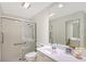 Accessible bathroom with glass shower, grab bars, and a spacious vanity with a large mirror at 5787 Ivrea Dr, Sarasota, FL 34238