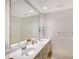 Well-lit bathroom with double sinks, a large mirror, and plenty of counter space at 5787 Ivrea Dr, Sarasota, FL 34238