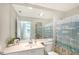 Bright bathroom with a large mirror, vanity, and a bathtub with a nautical-themed shower curtain at 5787 Ivrea Dr, Sarasota, FL 34238