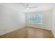 Bright bedroom features hard wood floors, ceiling fan, and a large window overlooking the water at 5787 Ivrea Dr, Sarasota, FL 34238