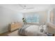Bright bedroom with a ceiling fan, hard wood floors, large window and decor at 5787 Ivrea Dr, Sarasota, FL 34238