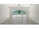 Bright bedroom with scenic backyard view through sliding glass doors at 5787 Ivrea Dr, Sarasota, FL 34238