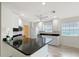 Well-lit kitchen features white cabinetry, stainless steel appliances, and dark granite countertops at 5787 Ivrea Dr, Sarasota, FL 34238