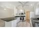 Modern kitchen features white cabinets, stainless steel appliances, and granite countertops with breakfast bar at 5787 Ivrea Dr, Sarasota, FL 34238