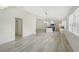 Bright open floor plan featuring white-painted walls, hardwood floors and an open kitchen at 5787 Ivrea Dr, Sarasota, FL 34238