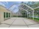 Covered lanai with sliding glass doors with a view of the lake at 5787 Ivrea Dr, Sarasota, FL 34238