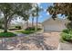 Charming home with brick driveway, lush landscaping, and two-car garage at 5787 Ivrea Dr, Sarasota, FL 34238