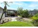 Lush backyard featuring a screened-in patio and tropical landscaping at 5905 32Nd E St, Ellenton, FL 34222