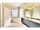 Elegant bathroom featuring a soaking tub, dual sinks, and a large mirror at 5905 32Nd E St, Ellenton, FL 34222
