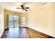 Well-lit bedroom with wood floors, ceiling fan, and a view of the pool at 5905 32Nd E St, Ellenton, FL 34222