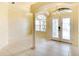Bright foyer featuring tile floors, a decorative chandelier, and double doors with glass inserts at 5905 32Nd E St, Ellenton, FL 34222