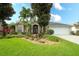 Charming single-story home with lush landscaping, rock water feature, and a well-manicured lawn at 5905 32Nd E St, Ellenton, FL 34222