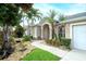 Beautiful home with a landscaped front yard, stone accents, and a walkway leading to the front door at 5905 32Nd E St, Ellenton, FL 34222