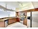Well-lit kitchen with stainless steel appliances, granite counters, tile floor, and wood cabinetry at 5905 32Nd E St, Ellenton, FL 34222