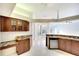 Open kitchen boasts wood cabinets, granite countertops, and flows into adjacent dining area at 5905 32Nd E St, Ellenton, FL 34222