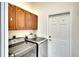 Laundry room with modern washer and dryer and wood cabinets at 5905 32Nd E St, Ellenton, FL 34222