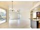 Open living area with tile floors, chandelier, open to the kitchen, and views of the backyard pond at 5905 32Nd E St, Ellenton, FL 34222