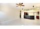 Open-concept living room with tile floors, a kitchen bar, and a view into the kitchen at 5905 32Nd E St, Ellenton, FL 34222