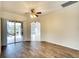Bright living room with wood floors, crown molding, and sliding glass doors to the outdoor patio at 5905 32Nd E St, Ellenton, FL 34222
