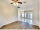 Spacious living room with wood floors, neutral walls, open access to foyer, and elegant ceiling fan at 5905 32Nd E St, Ellenton, FL 34222