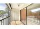 Relaxing screened balcony with tiled floor, door to storage and beautiful neighborhood views at 631 N Orange Ave # 208, Sarasota, FL 34236