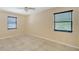 The bright bedroom features neutral paint, tile floors, and a large window at 631 N Orange Ave # 208, Sarasota, FL 34236