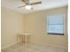 This bedroom has a ceiling fan, tile floors, and a window at 631 N Orange Ave # 208, Sarasota, FL 34236
