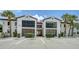 Charming condo exterior with two-story units, balconies and well maintained landscaping at 631 N Orange Ave # 208, Sarasota, FL 34236