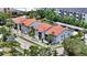 Stunning aerial view of the white apartments, showcasing their red tile roofs and verdant landscaping against a sunny backdrop at 631 N Orange Ave # 208, Sarasota, FL 34236
