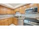 Modern kitchen with stainless steel appliances, granite countertops, and white tile backsplash at 631 N Orange Ave # 208, Sarasota, FL 34236