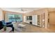 Cozy living room with dining area, large window, and contemporary shelving unit at 631 N Orange Ave # 208, Sarasota, FL 34236