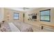 Spacious main bedroom with tile floors, decorative shelving, and a ceiling fan at 631 N Orange Ave # 208, Sarasota, FL 34236