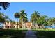 Majestic mansion framed by towering palm trees and lush greenery, evoking a sense of grandeur and elegance at 631 N Orange Ave # 208, Sarasota, FL 34236