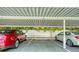 Assigned covered parking area with ample space and convenient access to the building, enhancing residents' vehicles' protection at 631 N Orange Ave # 208, Sarasota, FL 34236