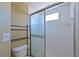 Bathroom featuring a shower with glass sliding doors and ceramic white tile at 6335 Bay Cedar Ln, Bradenton, FL 34203